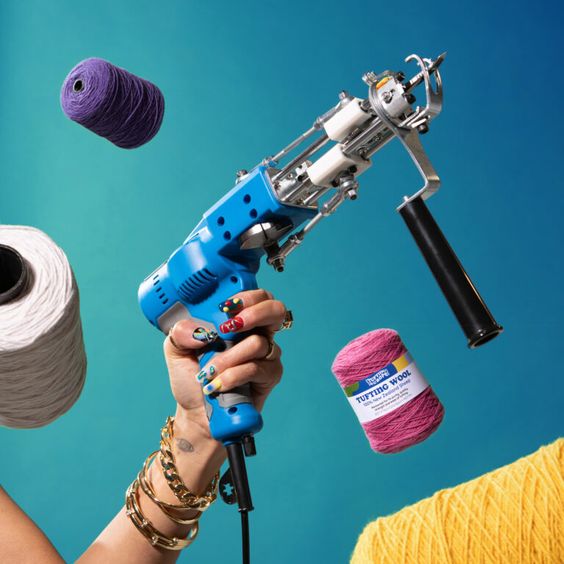 a woman hand holding a tufting gun